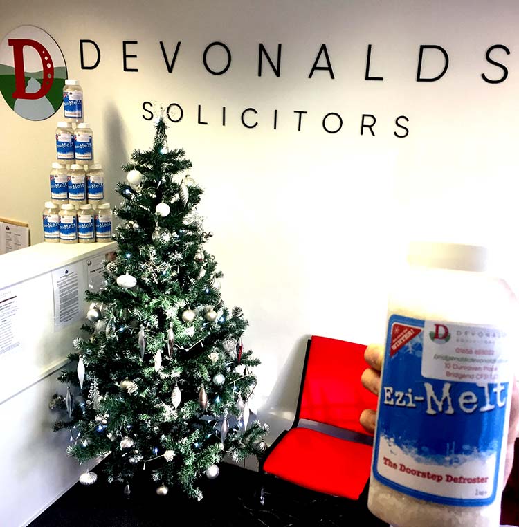 Huge bag of defrosting salt next to a christmas tree in Devonald's office